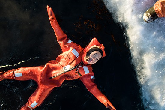 floating on ice with drysuit on our polar icebreaker tour